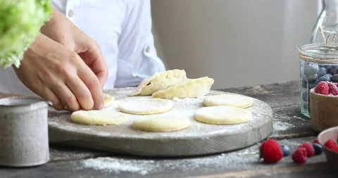 The process of making homemade dumplings. Raw pierogi  with berry Stock Footage 158307252