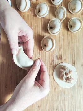The process of making homemade dumplings. Raw homemade dumplings with meat on Stock Photos