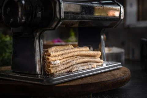 Process of making homemade wholewheat pasta in a kitchen with pasta sheet roller Stock Photos