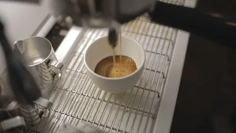 Process of making hot coffee in a coffee machine. Barista making fresh coffee in Stock Footage 241189194