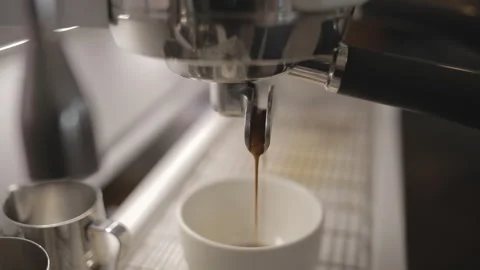Process of making hot coffee in a coffee machine. Barista making fresh coffee in Stock Footage 241189281