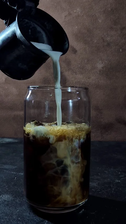 The process of making an iced latte in a glass Stock Footage 305062719