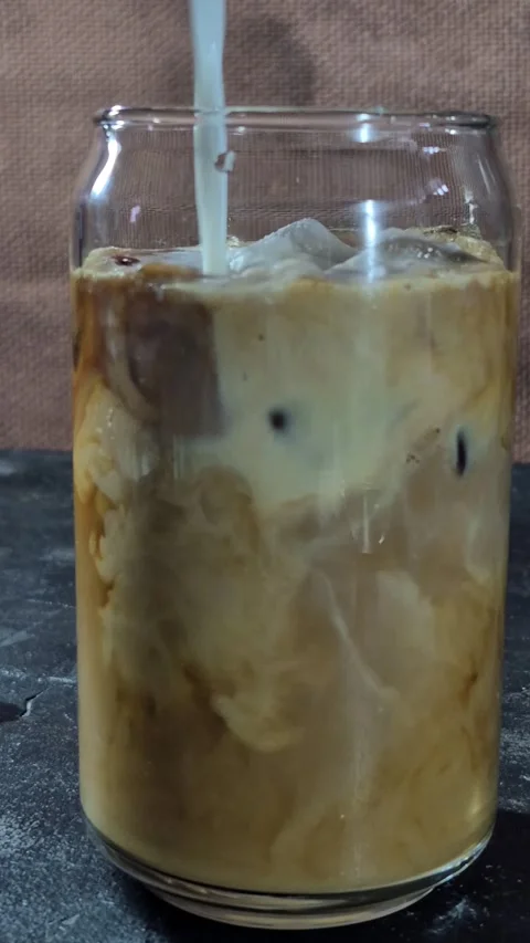 The process of making an iced latte in a glass Stock Footage 305062729