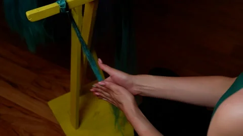 The process of making kanekalon dreadlocks. Female hands twist a bunch of kan Stock Footage 155307942