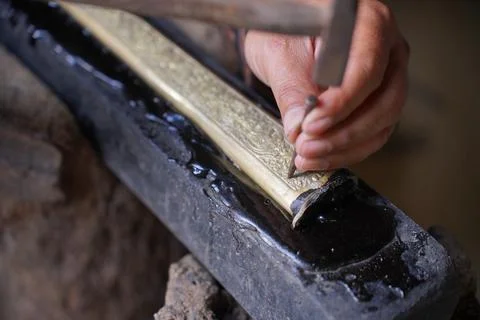 The process of making a keris is being carved to make traditional ornaments Stock Photos