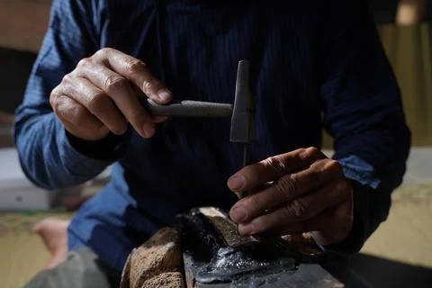The process of making a keris is being carved to make traditional ornaments Stock Photos