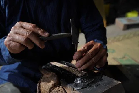 The process of making a keris is being carved to make traditional ornaments Stock Photos