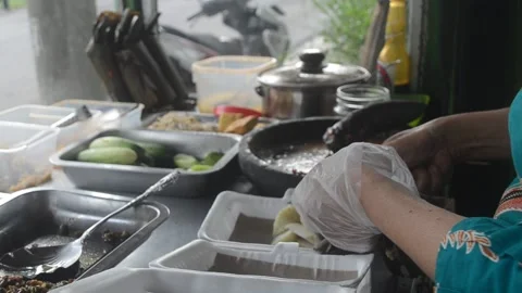 The process of making Kupat Tahu typical of Indonesian traditional food Stock Footage 221888868