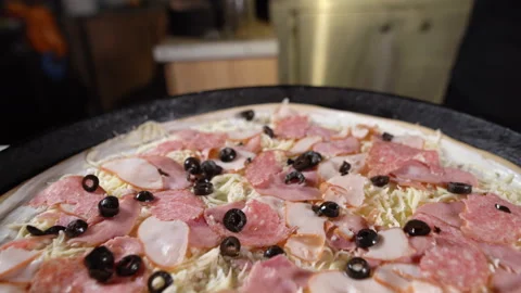 The process of making a large pizza. The chef's hands in black gloves are Stock Footage 152872152