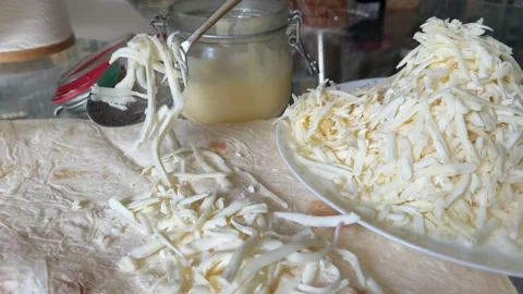 Process of making lavash with cheese Cook is adding hard cheese on pita. Process Stock Footage 317221647