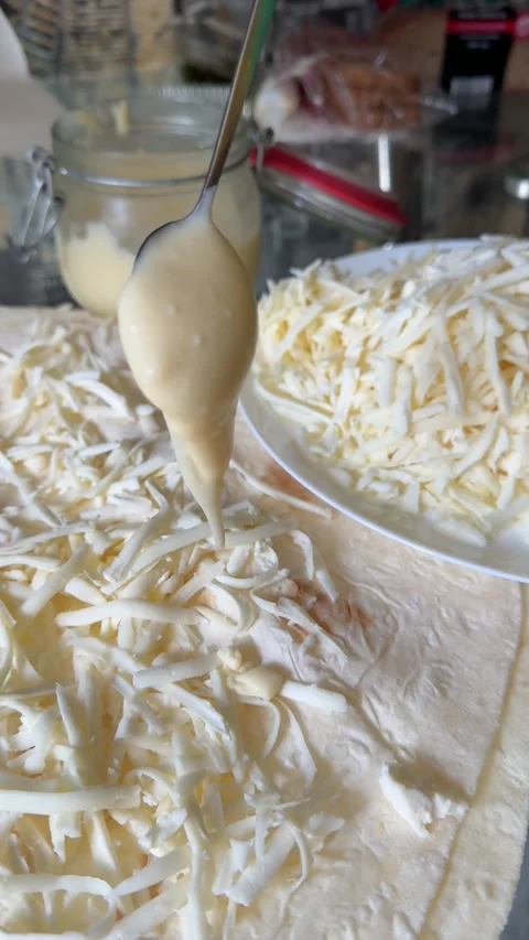 Process of making lavash with cheese Cook is adding hard cheese on pita. Process Stock Footage 317222135