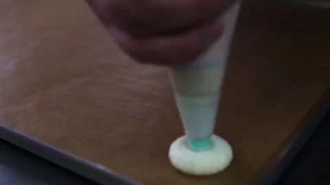 Process of making macaron, french dessert, squeezing the dough form cooking bag Stock Footage 70774196