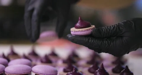 Process of making macaron macaroon, french dessert. Assembly of two halves with Stock Footage 148689263