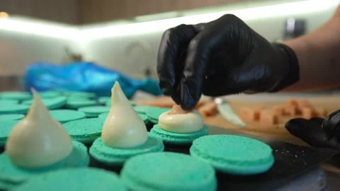 Process Of Making macaroon at home. Shot of hands of female pastry chef holding Видео 153668590