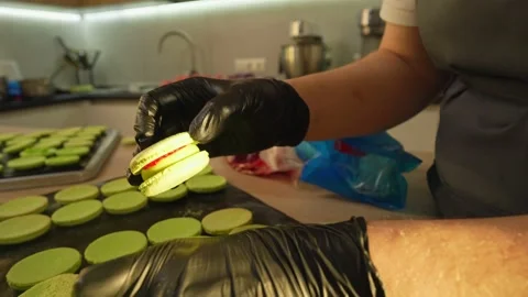 Process Of Making macaroon at home. Shot of hands of female pastry chef holding Video stock 153668962