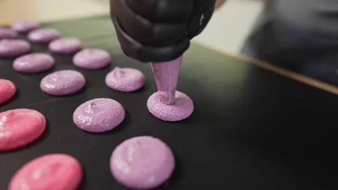 Process Of Making macaroon at home. Shot of hands of female pastry chef holding Video stock 153669636
