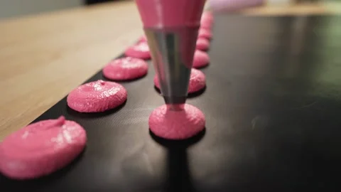 Process Of Making macaroon at home. Shot of hands of female pastry chef holding Stock Footage 153688215