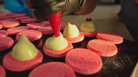 Process Of Making macaroon at home. Shot of hands of female pastry chef holding Stock Footage 153690223