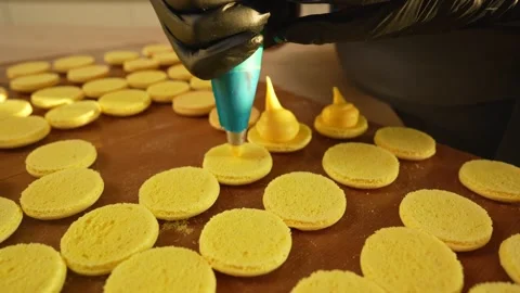 Process Of Making macaroon at home. Shot of hands of female pastry chef holding Stock Footage 153690547