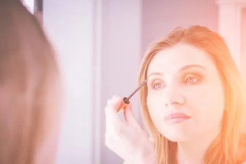 Process of making makeup artist working with brush on model face Stock Photos
