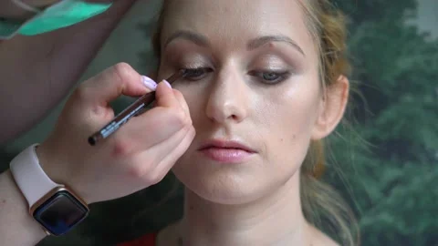 Process of making makeup. Make-up artist applied with brush on model face. Stock Footage 138076674