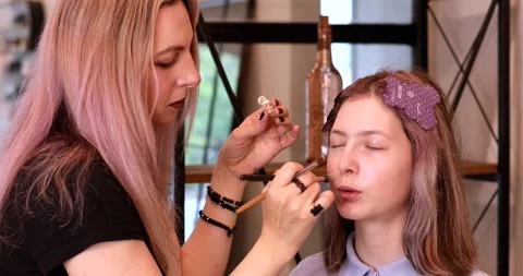 Process of making makeup. Make-up artist working with brush on model face. Stock Footage 310161280