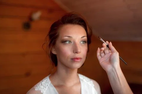 Process of making makeup. Make-up artist working with brush on model face Stock Photos