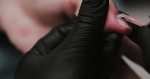 Process of making manicure, macro. Closeup of applying base coat on client  Video stock 149367205