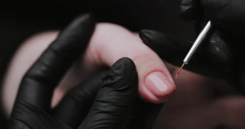 Process of making manicure, macro. Closeup of applying base coat on client  Stock Footage 149367328