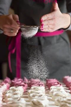 Process of making marshmallow. Close up hands of the chef with metal sieve sp Stock Photos