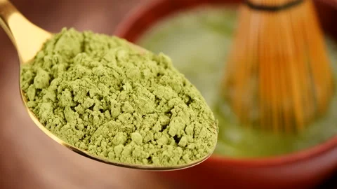 Process making matcha green tea. Matcha tea powder in golden spoon Stock Footage 229550722