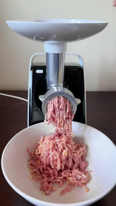 Process of making minced meat with electric meat grinder in home kitchen Stock Footage 318544424