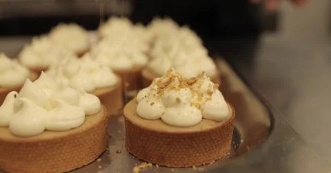 The process of making mini tarts. Sprinkle and decorate mini tarts with gra.. Stock Photos