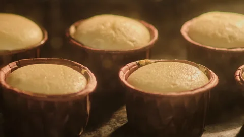 The process of making muffins in the oven, timelapse. Cupcake dough rises at the Stock Footage 255706637