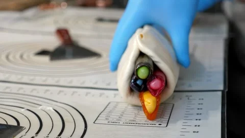 The process of making multi-colored lollipops in a confectionery kitchen. Stock Footage 330522206