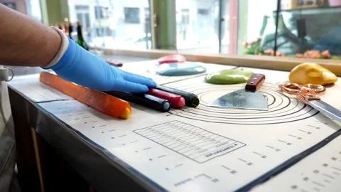 The process of making multi-colored lollipops in a confectionery kitchen. Stock Footage 331696505
