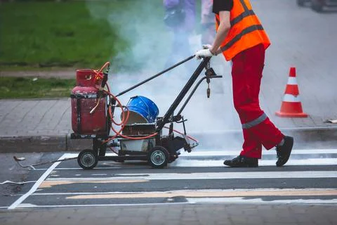 Process of making new road surface markings with a line striping machine, w.. Stock Photos