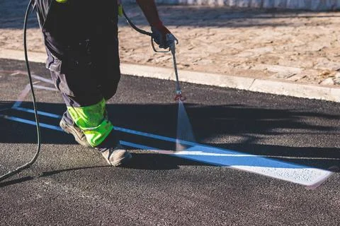 Process of making new road surface markings with a line striping machine, w.. Stock Photos