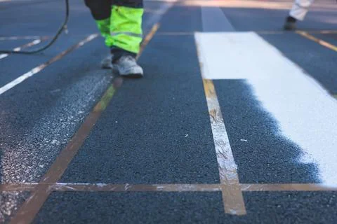 Process of making new road surface markings with a line striping machine, w.. Stock Photos