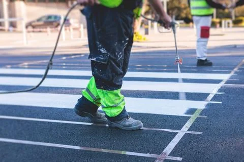 Process of making new road surface markings with a line striping machine, w.. Stock Photos