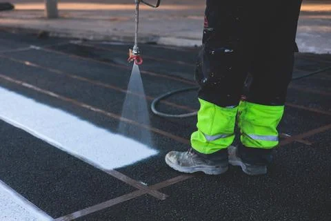 Process of making new road surface markings with a line striping machine, w.. Stock Photos