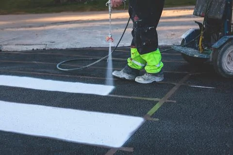 Process of making new road surface markings with a line striping machine, w.. Stock Photos