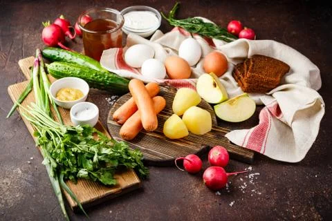 Process of making Okroshka soup. Chopping radish, sausage and other ingredien Stock Photos
