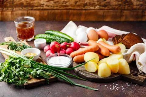 Process of making Okroshka soup. Chopping radish, sausage and other ingredien Stock Photos