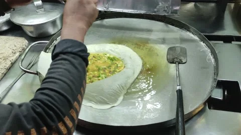 The process of making or cooking an Martabak Telur Stock-Footage 218168770