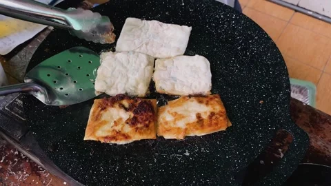 Process of making or cooking martabak eggs, Indonesian street food. Stock Footage 297965348