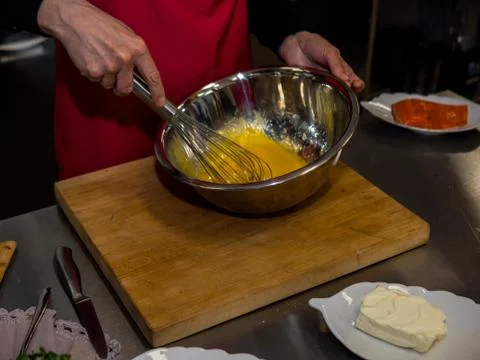 The process of making pancakes. Cook in the kitchen makes the dough Фото