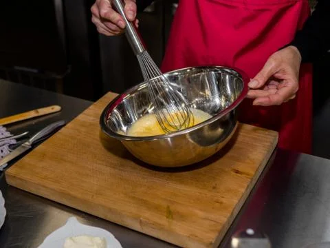 The process of making pancakes. Cook in the kitchen makes the dough Stock-Fotos