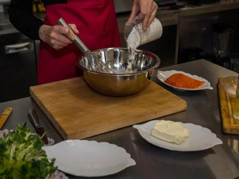 The process of making pancakes. Cook in the kitchen makes the dough Stock Photos