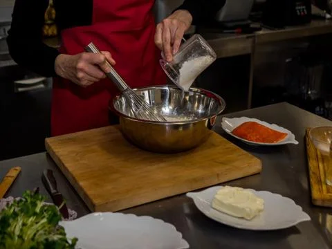 The process of making pancakes. Cook in the kitchen makes the dough Stock Photos
